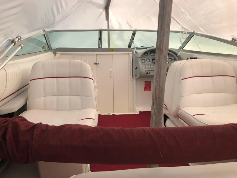 Slide: The Image of 1994 Sea Ray Overnighter boat interior with white seating and red accents. - 13