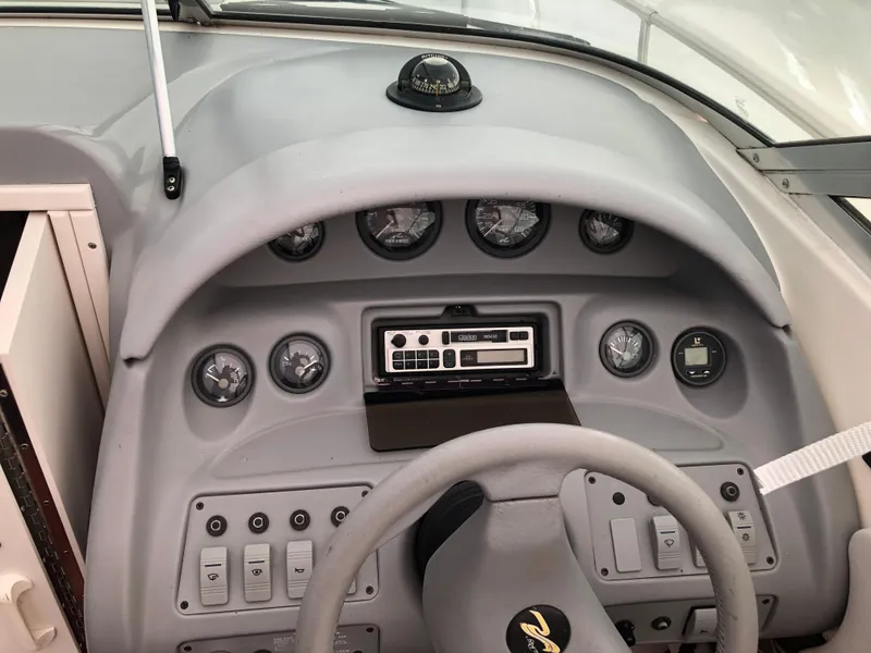 Slide: The Image of 1994 Sea Ray Overnighter dashboard with gauges and controls. - 14
