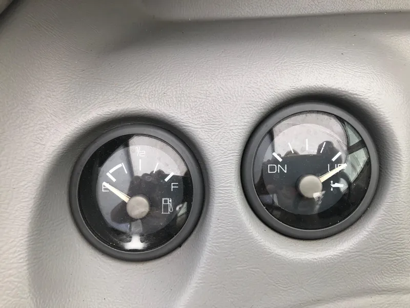 Slide: The Image of Dashboard gauges of a 1994 Sea Ray Overnighter boat, showing fuel and trim levels. - 18