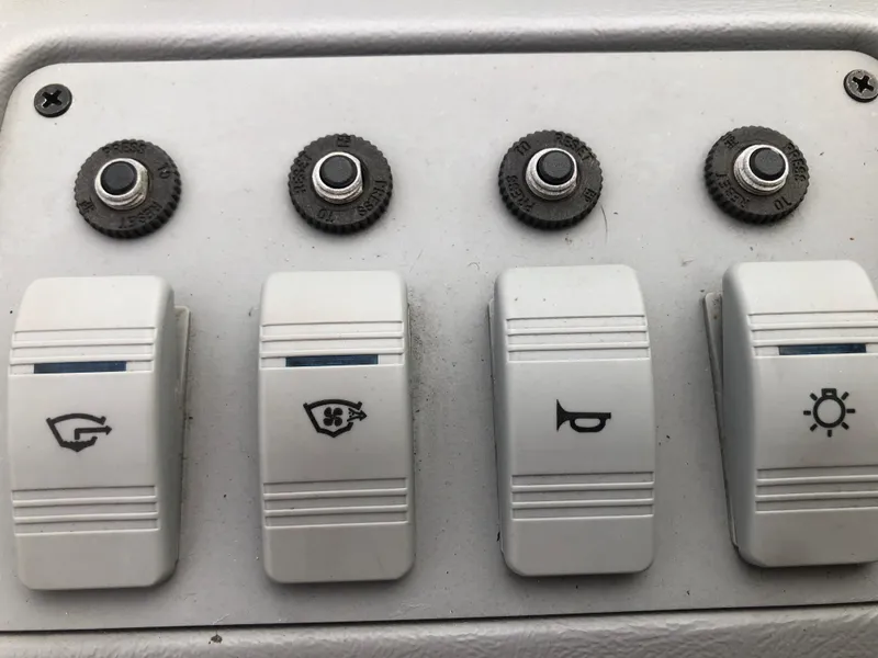 Slide: The Image of Control panel of a 1994 Sea Ray Overnighter boat with labeled switches. - 19