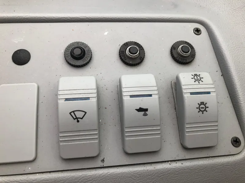 Slide: The Image of Control panel of a 1994 Sea Ray Overnighter boat with switches and buttons. - 20