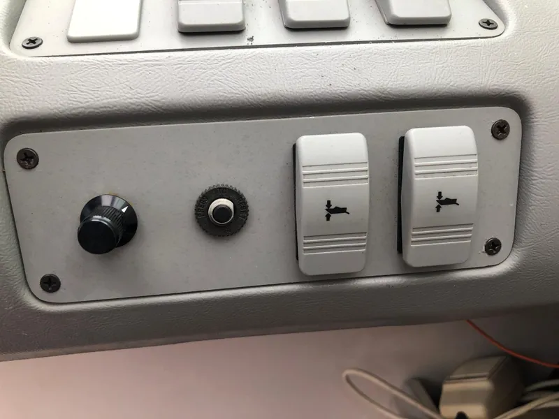 Slide: The Image of Control panel of a 1994 Sea Ray Overnighter boat with switches and knobs. - 21