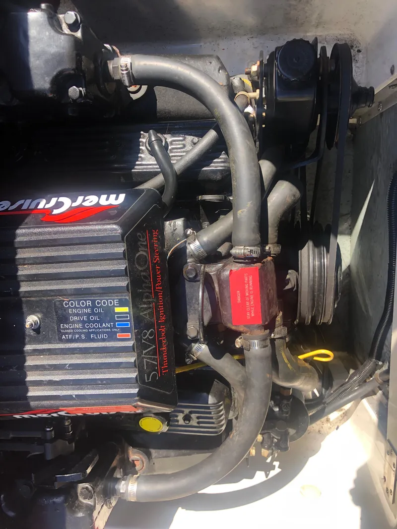 Slide: The Image of 1994 Sea Ray Overnighter engine compartment with MerCruiser components and hoses. - 35