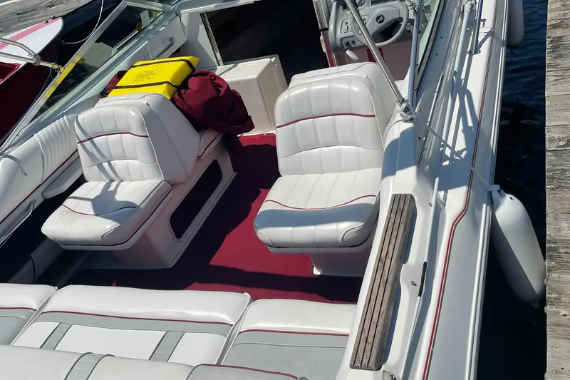 Slide: The Image of 1994 Sea Ray Overnighter boat with white leather seats and red carpet interior. - 4