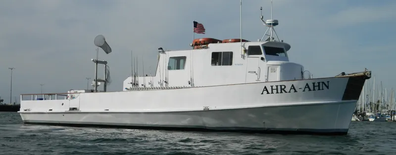 The Image of 1958 Ditmar & Donaldson sport boat "AHRA-AHN" on water with American flag. - 0