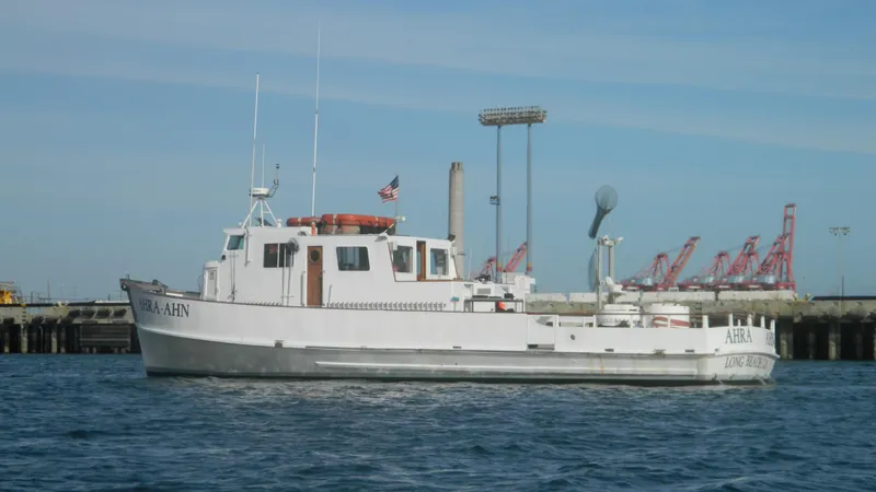 Slide: The Image of 1958 Ditmar & Donaldson sport boat docked near industrial port. - 2