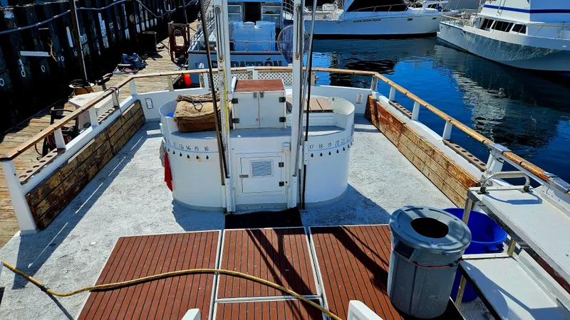 Slide: The Image of 1958 Ditmar & Donaldson sport boat docked, featuring wooden deck and marina backdrop. - 5