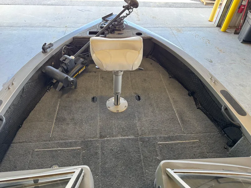 Slide: The Image of 2013 Crestliner 1850 Fish Hawk boat interior with swivel seat and trolling motor. - 11