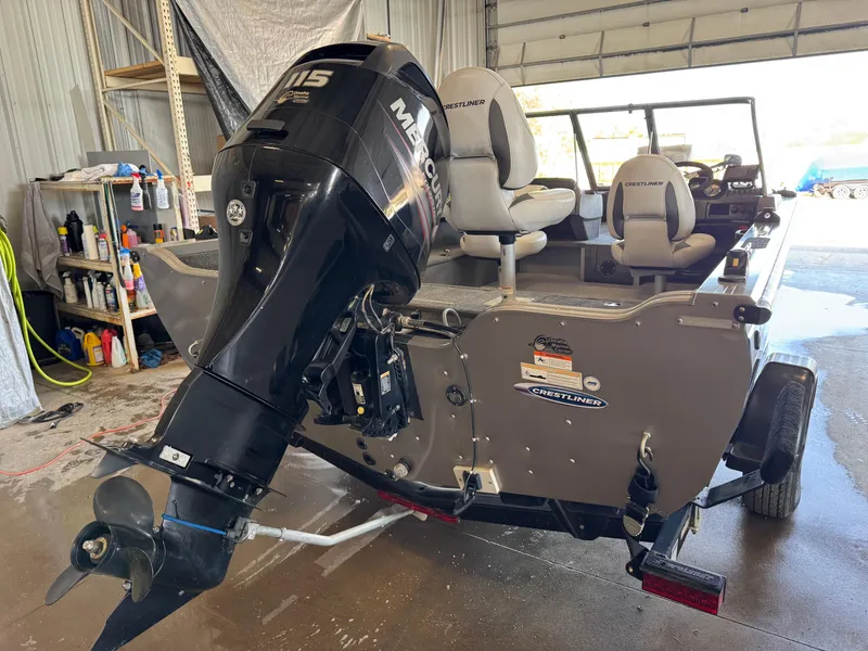 Slide: The Image of 2013 Crestliner 1850 Fish Hawk boat with Mercury 115 outboard motor in a garage. - 4