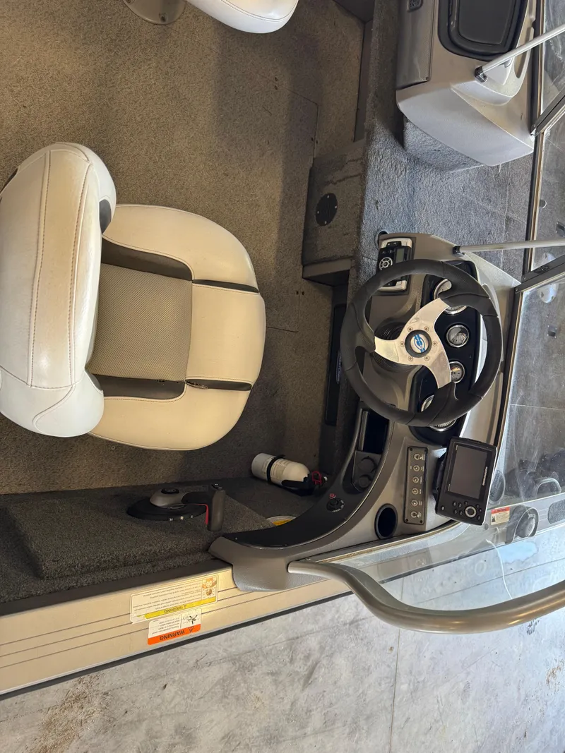 Slide: The Image of 2013 Crestliner 1850 Fish Hawk boat interior with steering wheel and seat. - 7