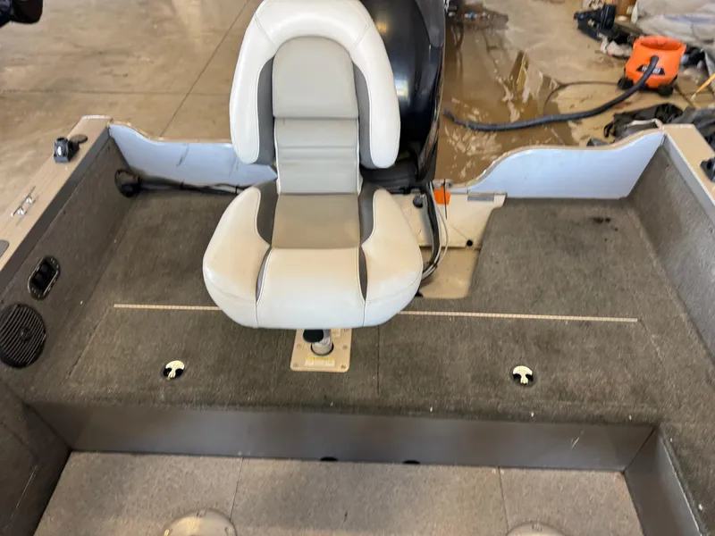 Slide: The Image of 2013 Crestliner 1850 Fish Hawk boat interior with a central seat and carpeted flooring. - 9