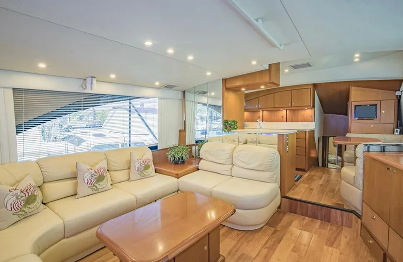 Slide: The Image of Luxurious interior of 1999 Ocean Yachts 60 Convertible with plush seating and wooden accents. - 10