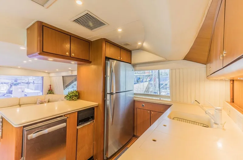 Slide: The Image of Luxurious kitchen interior of 1999 Ocean Yachts 60 Convertible with modern appliances. - 12