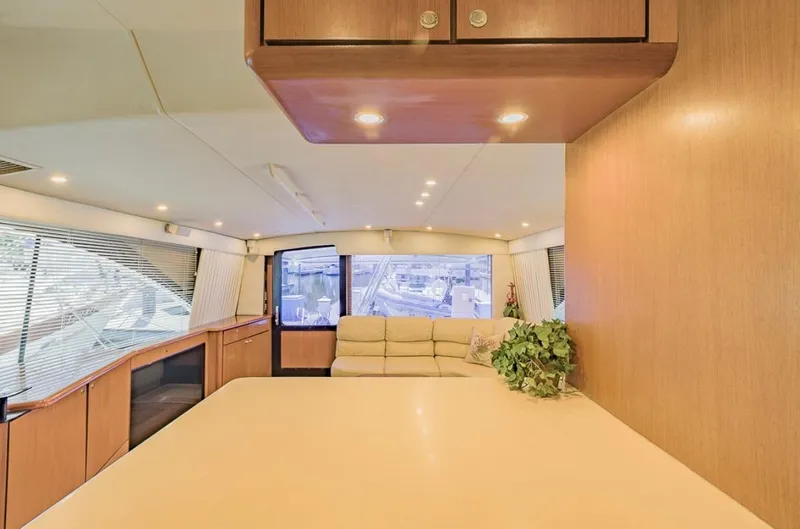 Slide: The Image of Luxurious interior of 1999 Ocean Yachts 60 Convertible with modern furnishings and ample natural light. - 13