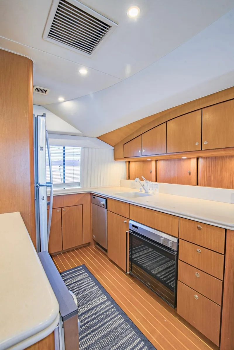 Slide: The Image of 1999 Ocean Yachts 60 Convertible kitchen with wood cabinetry and modern appliances. - 14
