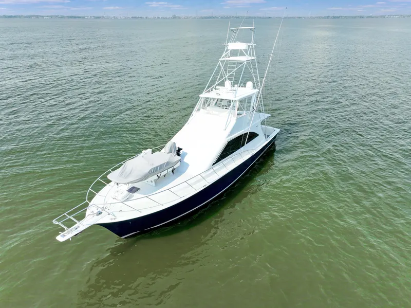 Slide: The Image of 1999 Ocean Yachts 60 Convertible cruising on open water, showcasing sleek design and spacious deck. - 2