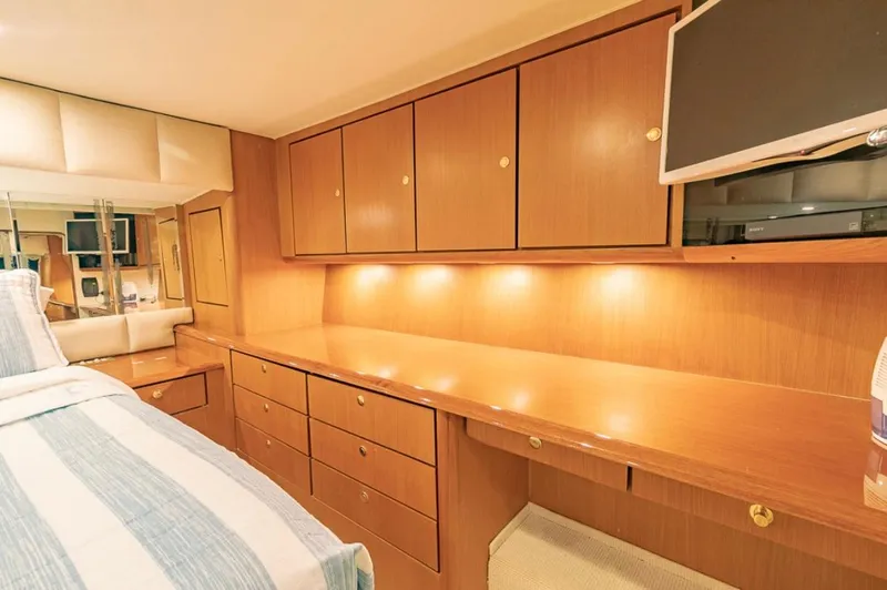 Slide: The Image of Luxurious cabin interior of a 1999 Ocean Yachts 60 Convertible with wood cabinetry and modern amenities. - 20