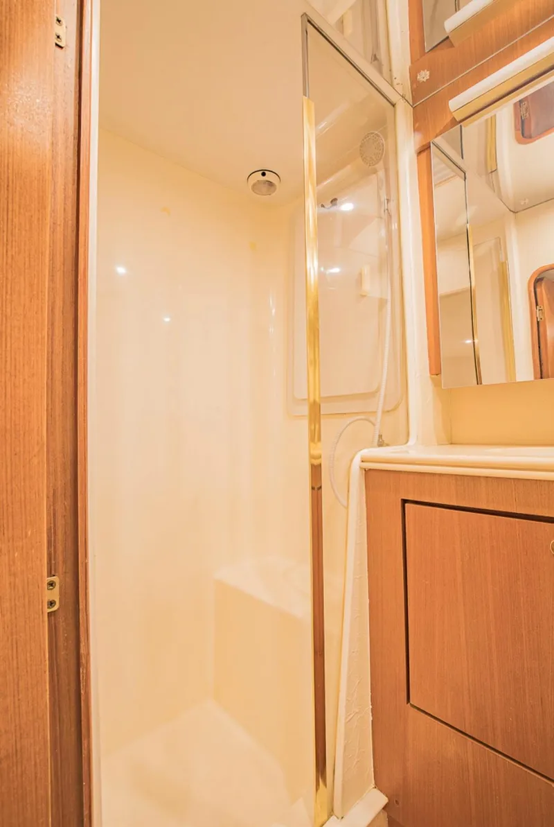 Slide: The Image of 1999 Ocean Yachts 60 Convertible yacht bathroom with shower and wooden cabinetry. - 21