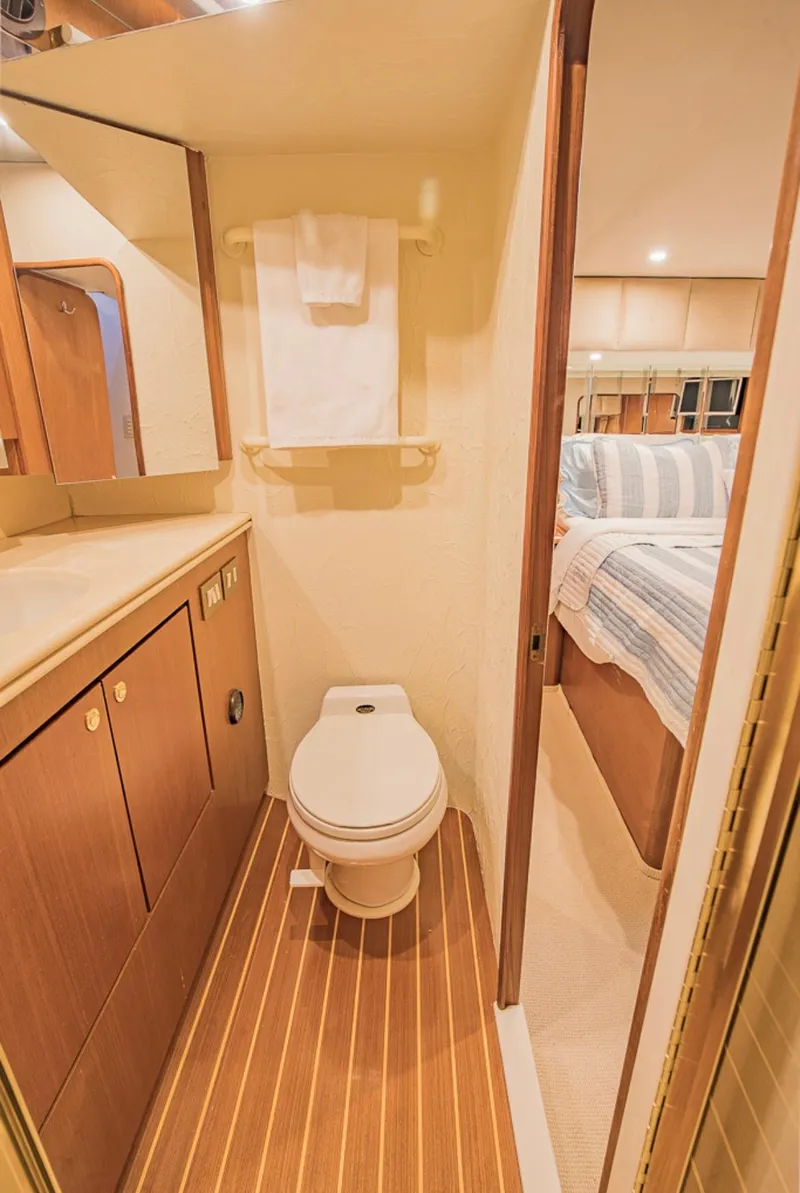 Slide: The Image of 1999 Ocean Yachts 60 Convertible bathroom with wood flooring and modern fixtures. - 23