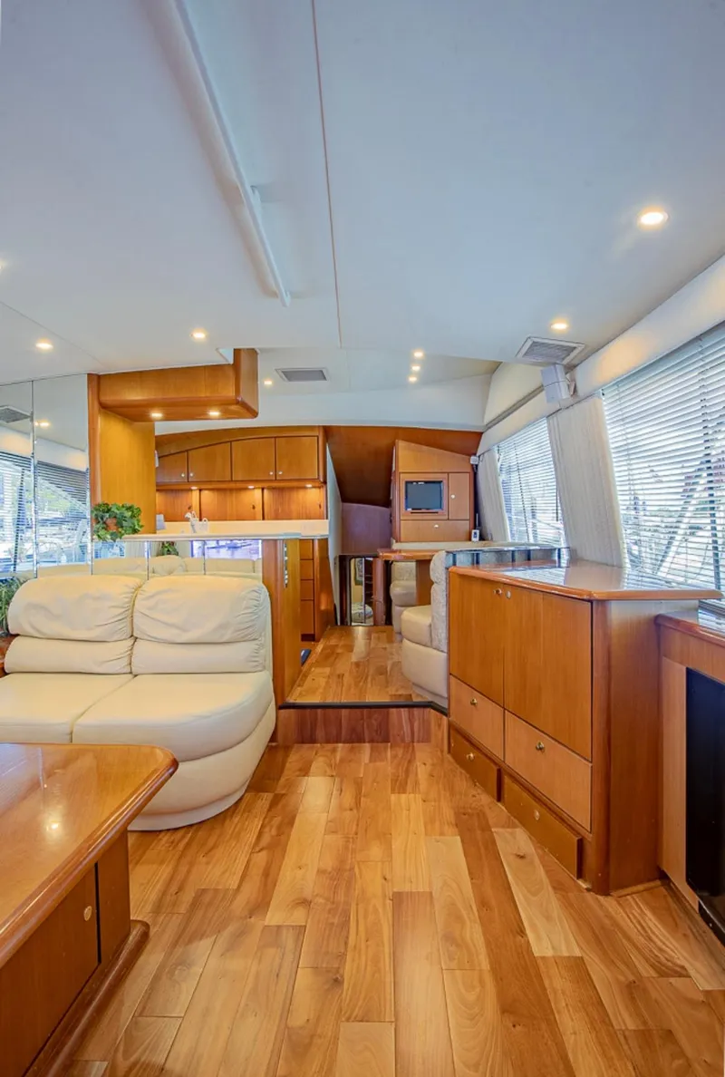 Slide: The Image of Luxurious interior of 1999 Ocean Yachts 60 Convertible with wooden flooring and modern furnishings. - 8