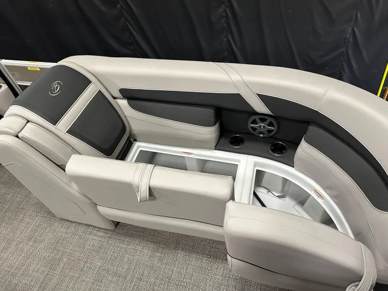 Slide: The Image of 2025 Barletta Cabrio 22QC boat interior with beige seating and cup holders. - 11
