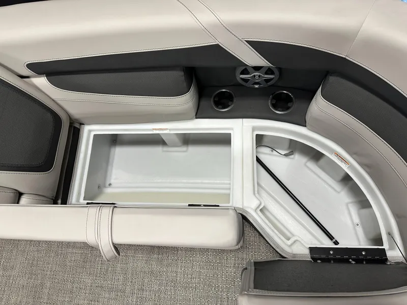 Slide: The Image of 2025 Barletta Cabrio 22QC boat interior storage compartment with cup holders and speaker. - 12