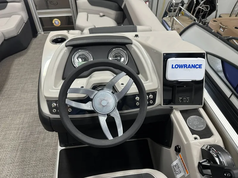 Slide: The Image of Steering console of 2025 Barletta Cabrio 22QC with Lowrance display and modern controls. - 17