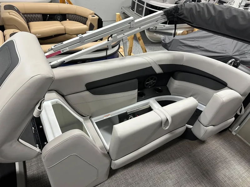 Slide: The Image of 2025 Barletta Cabrio 22QC boat interior with gray seating and storage compartments. - 20