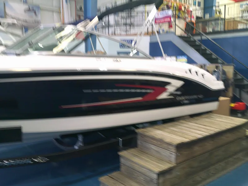 The Image of 2024 Chaparral 21 SSi boat displayed indoors on wooden platform. - 0