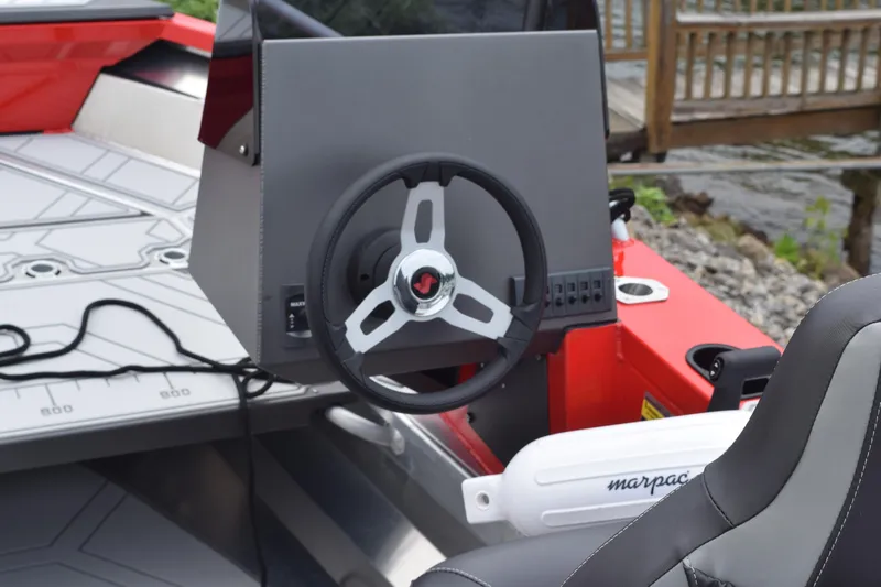 Slide: The Image of Stabicraft 1550 Frontier Profish 2025 boat steering console and seating area. - 10