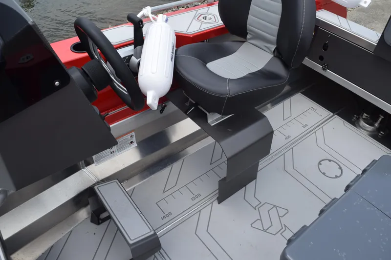 Slide: The Image of 2025 Stabicraft 1550 Frontier Profish boat interior with steering wheel and seating. - 15