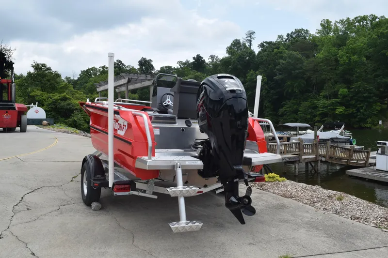Slide: The Image of 2025 Stabicraft 1550 Frontier Profish boat on trailer by a lakeside dock. - 3