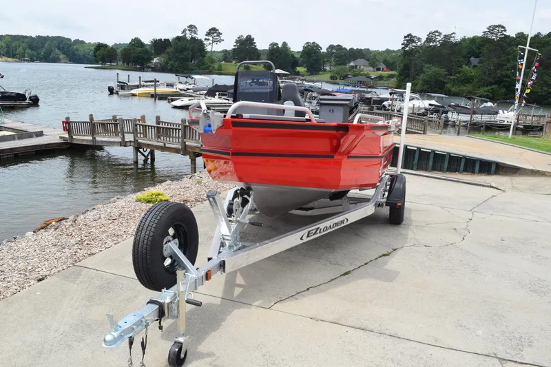 Slide: The Image of 2025 Stabicraft 1550 Frontier Profish boat on trailer by a lakeside dock. - 4