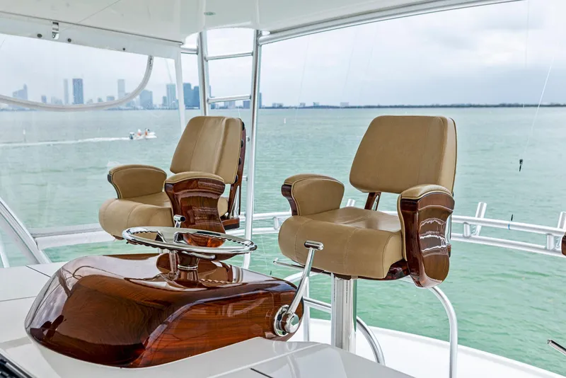 Slide: The Image of Luxury helm chairs on the 2018 Viking 80 Convertible yacht with ocean view. - 10