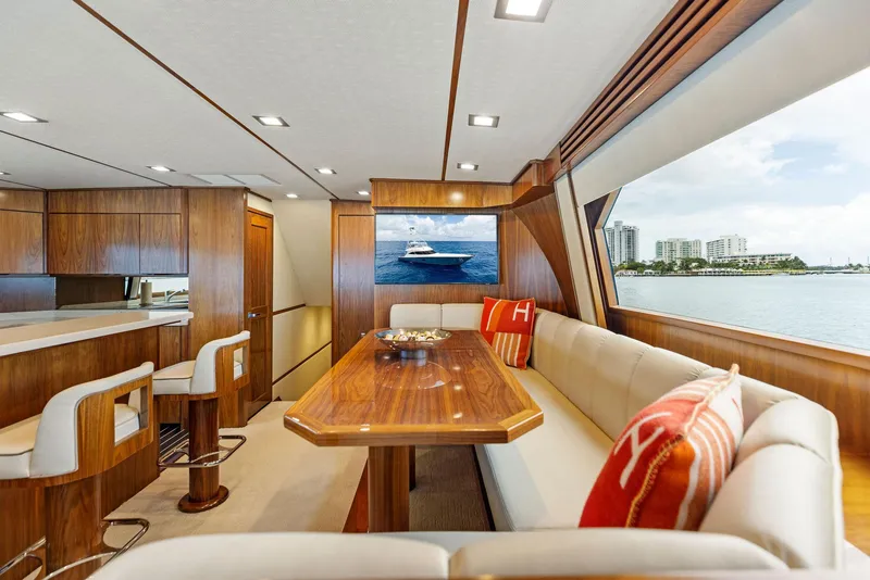 Slide: The Image of Luxurious interior of 2018 Viking 80 Convertible yacht with dining area and ocean view. - 16