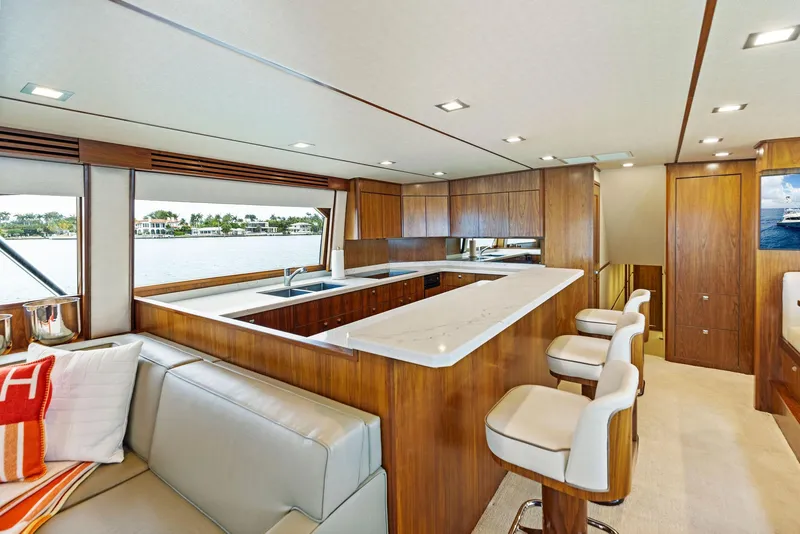 Slide: The Image of Luxurious interior of 2018 Viking 80 Convertible yacht with modern kitchen and seating area. - 17