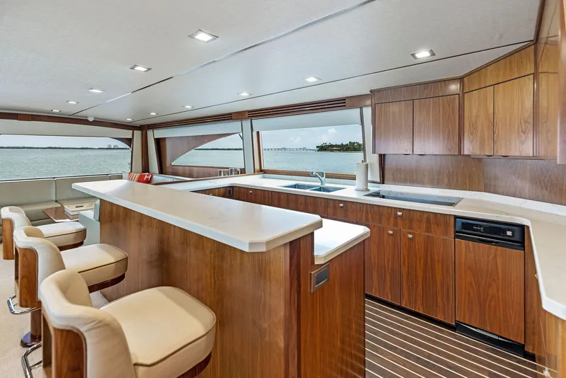 Slide: The Image of Luxurious kitchen area on a 2018 Viking 80 Convertible yacht with ocean view. - 18