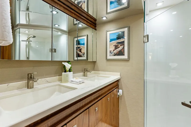 Slide: The Image of Luxurious bathroom in 2018 Viking 80 Convertible yacht with double sinks and glass shower. - 23