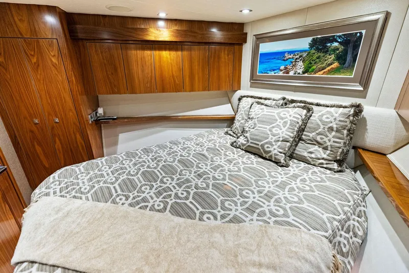 Slide: The Image of Luxurious bedroom interior of 2018 Viking 80 Convertible yacht with wooden cabinets. - 24