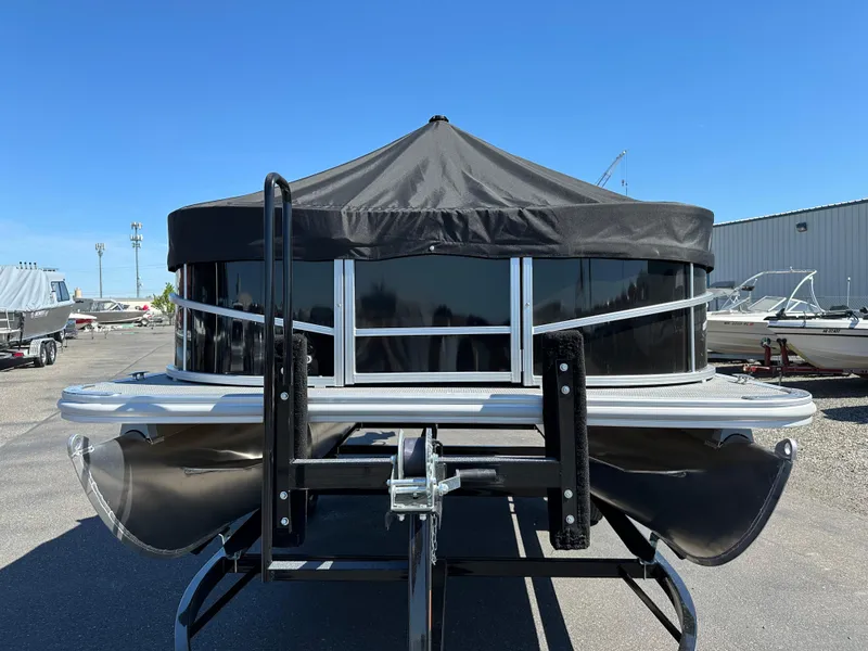 Slide: The Image of 2024 SunChaser Vista 18 Fish pontoon boat with black canopy, front view. - 2