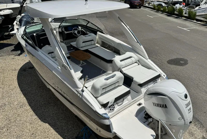 Slide: The Image of 2025 Regal LX6 boat with Yamaha engine, docked, featuring spacious seating and modern design. - 1