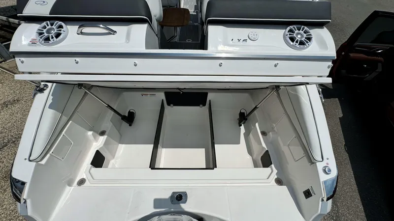 Slide: The Image of 2025 Regal LX6 boat with open storage compartment and speakers. - 10