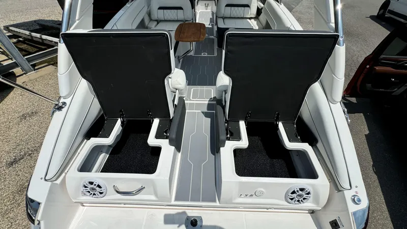 Slide: The Image of 2025 Regal LX6 boat interior with seating and storage compartments. - 11