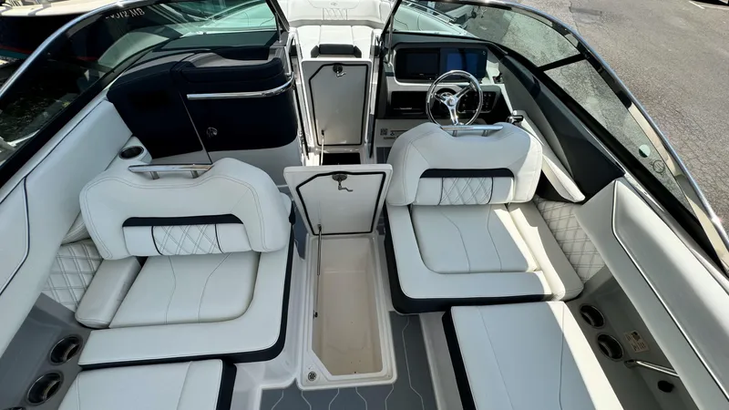 Slide: The Image of 2025 Regal LX6 boat interior with luxurious white seating and modern dashboard. - 12