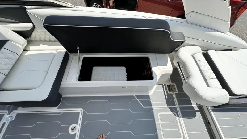 Slide: The Image of 2025 Regal LX6 boat with open storage compartment and luxurious seating. - 20