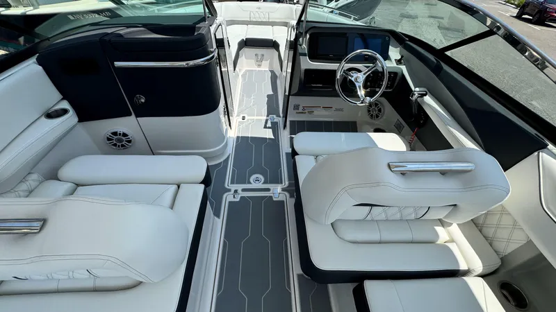 Slide: The Image of 2025 Regal LX6 boat interior with white leather seats and modern dashboard. - 22