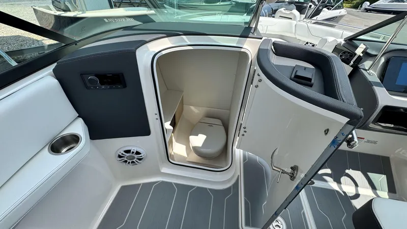 Slide: The Image of 2025 Regal LX6 boat interior with open bathroom door. - 27