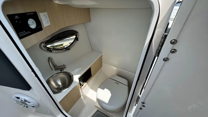 Slide: The Image of 2025 Regal LX6 boat interior bathroom with sink and toilet. - 28
