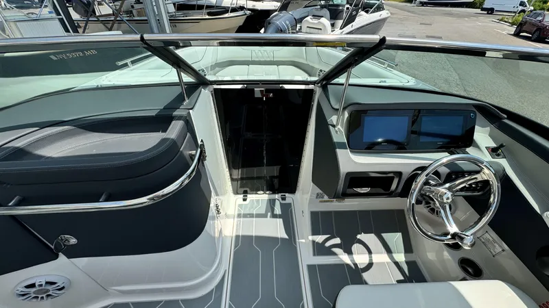 Slide: The Image of 2025 Regal LX6 boat cockpit with modern dashboard and steering wheel. - 29