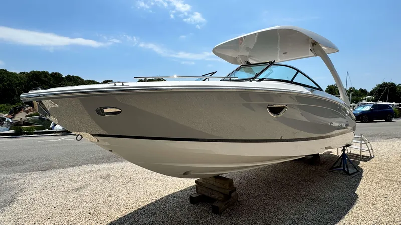 Slide: The Image of 2025 Regal LX6 boat on display under a clear blue sky. - 4